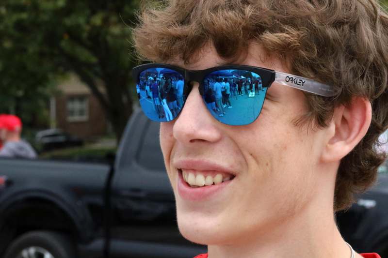 a man wearing sunglasses with blue lenses