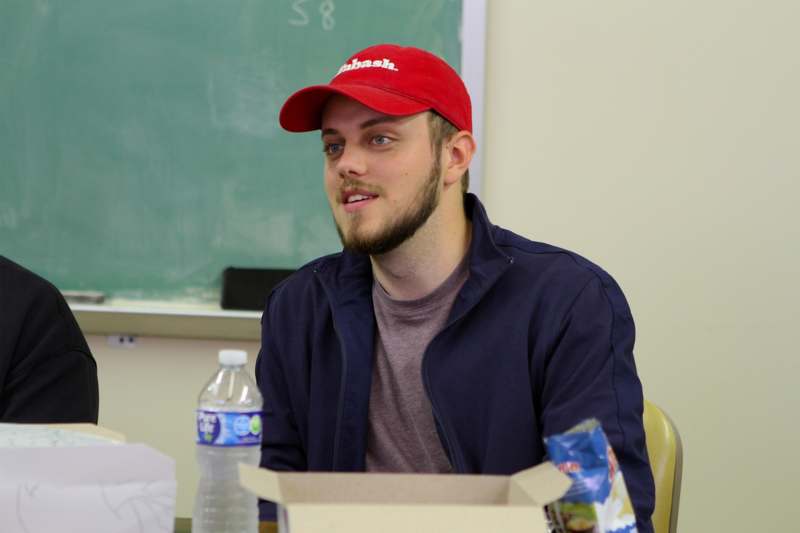 a man in a red hat sitting in a chair