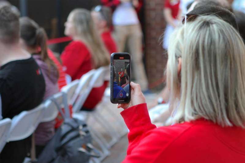 a woman taking a picture of a person