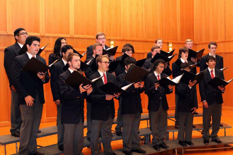 a group of people singing in a choir