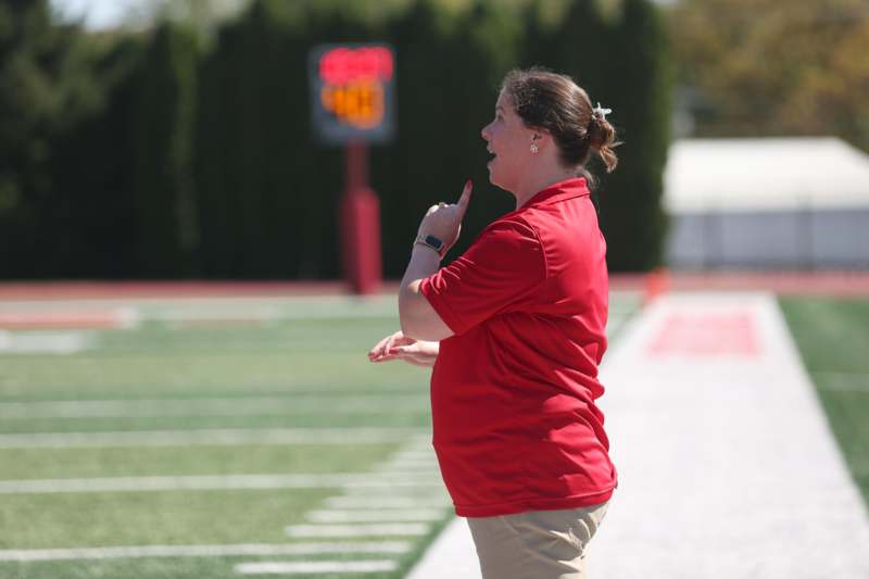 a woman in a red shirt on a football field