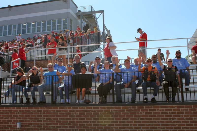 a group of people sitting on bleachers