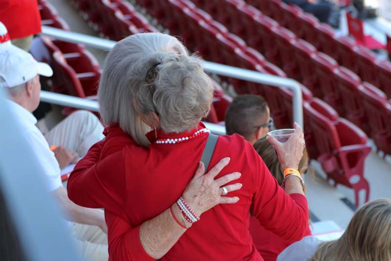 two women hugging in a stadium