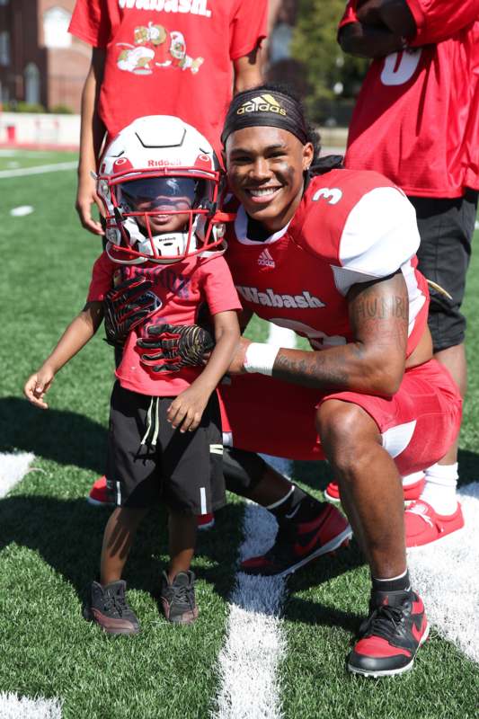 a man in a football uniform with a child
