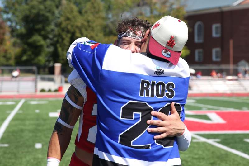 two men hugging on a football field