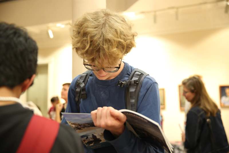 a boy looking at a book