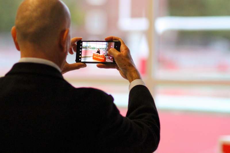 a man taking a picture of a basketball player