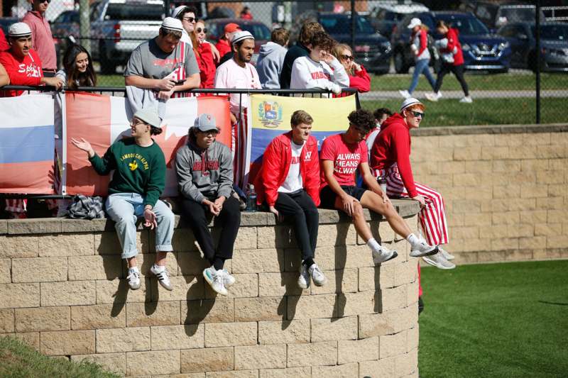a group of people sitting on a wall