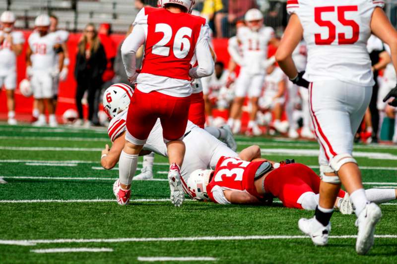 a football player falling down on the field