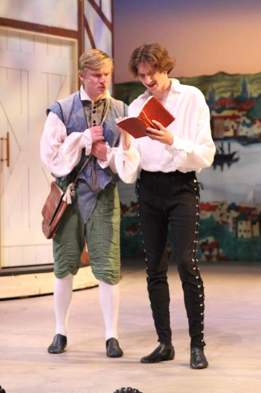 two men in garment on a stage