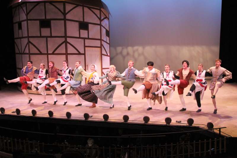 a group of people dancing on a stage