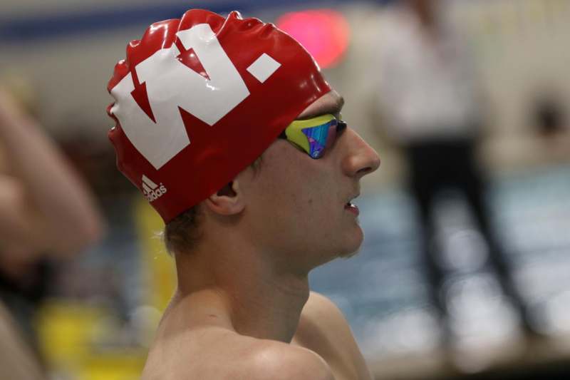 a man wearing a swim cap and goggles