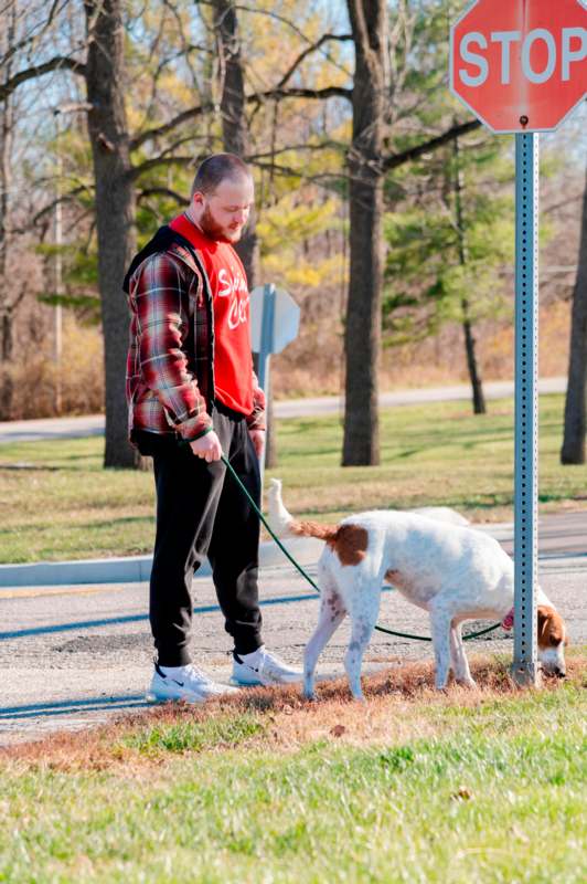 a man holding a dog on a leash