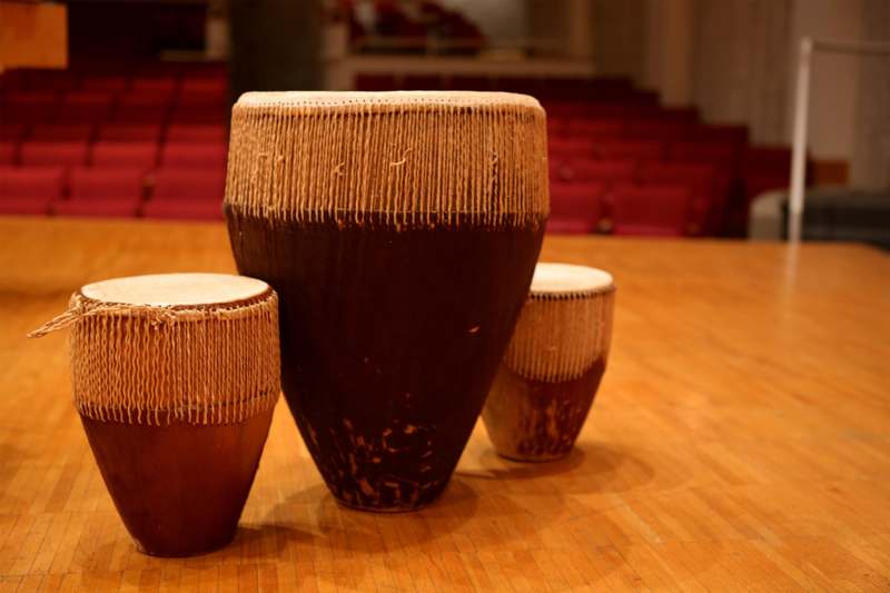 a group of drums on a wooden floor