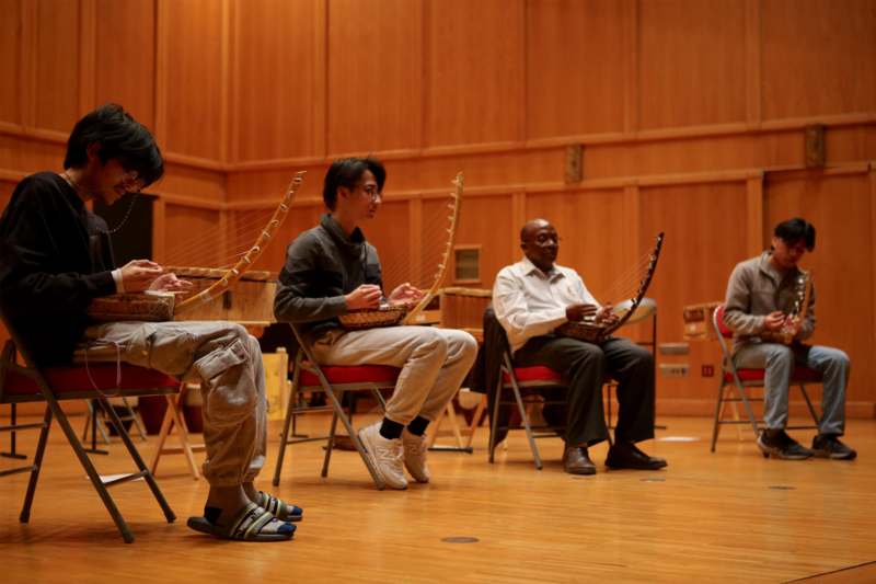 a group of people sitting in chairs playing instruments
