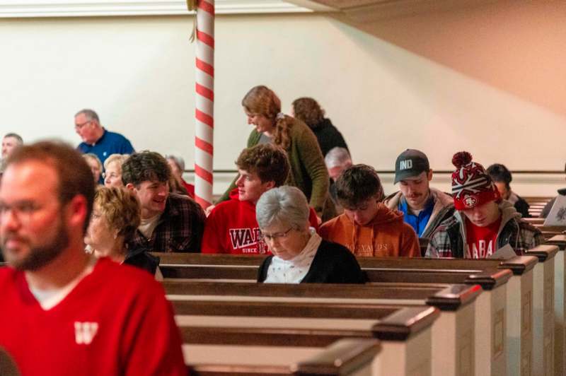 a group of people sitting in pews