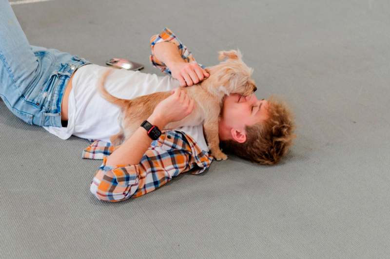 a man lying on the floor with a dog