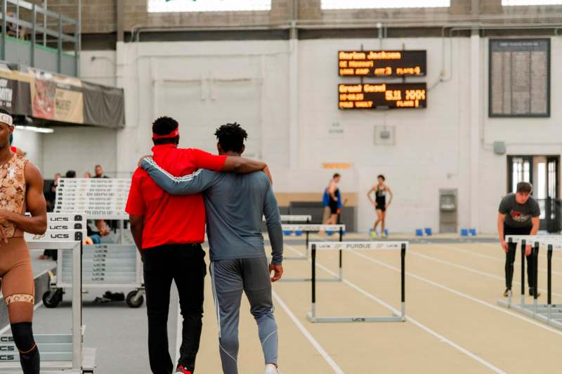 two people hugging on a track