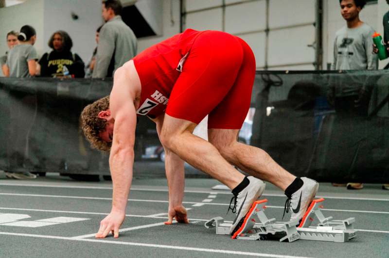 a man in red leotard on a track