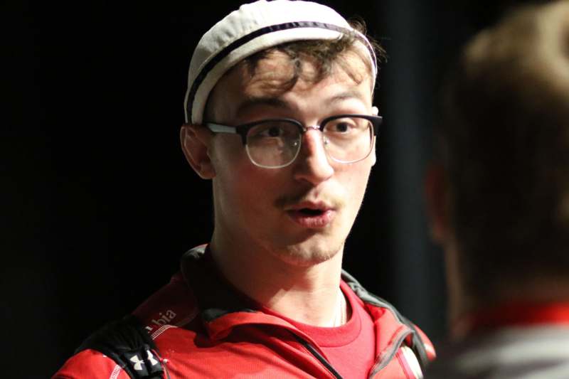 a man wearing glasses and a red shirt