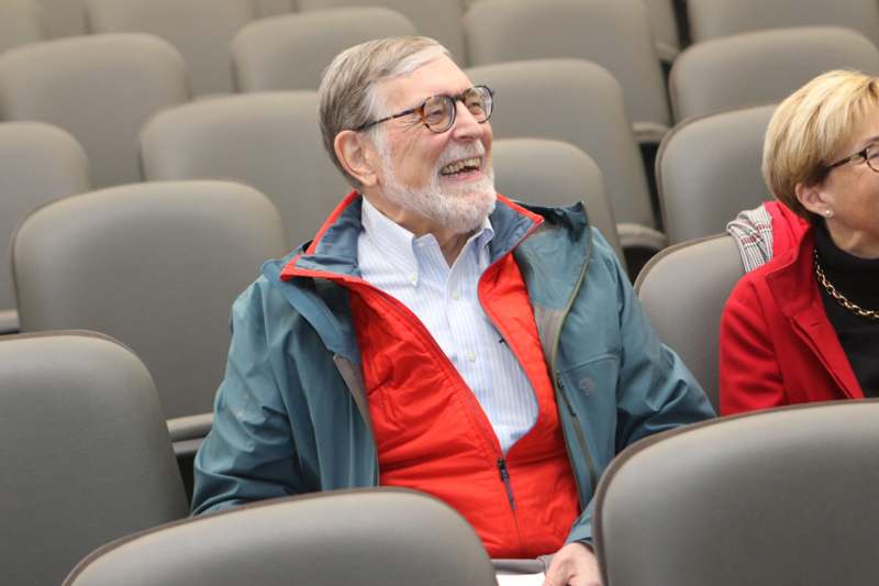 a man in a jacket laughing