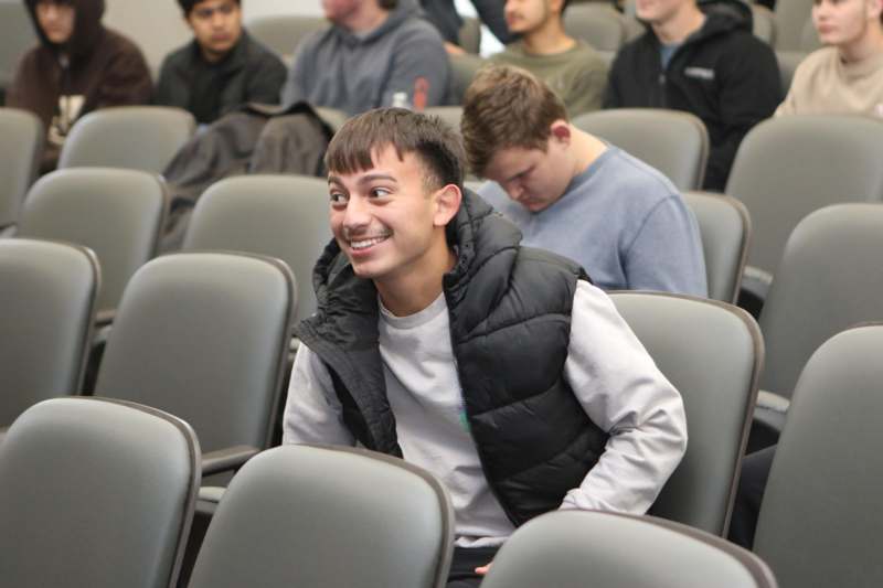 a man sitting in a lecture hall