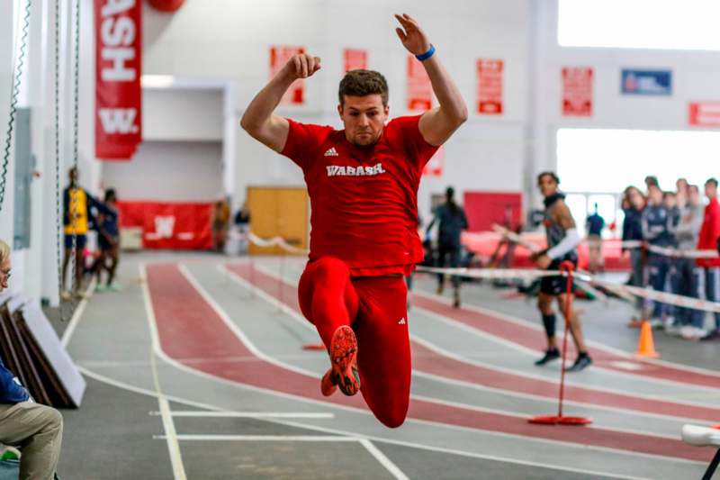 a man in red running on a track
