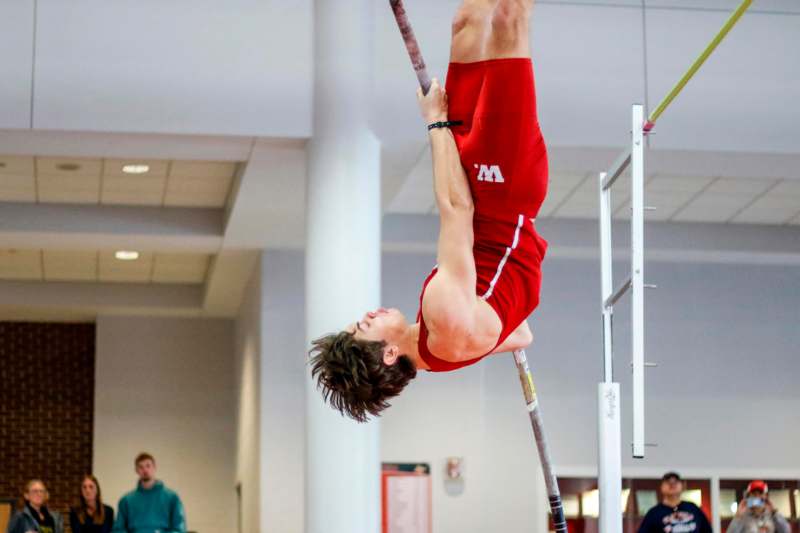a man in red shorts on a pole