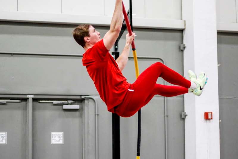 a man in red shirt from a pole