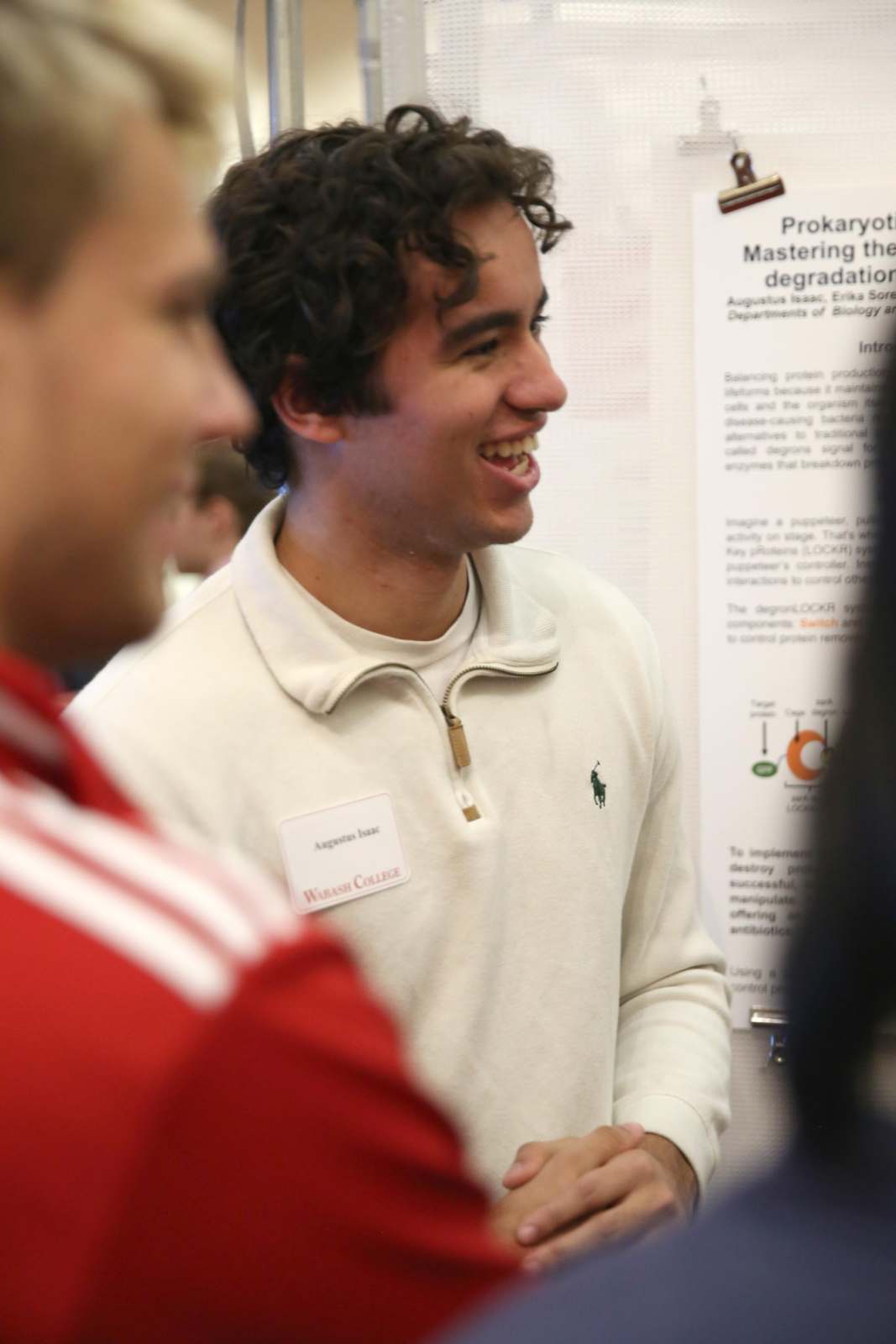 a man smiling at a presentation