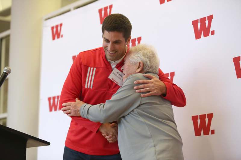 a man hugging an old woman