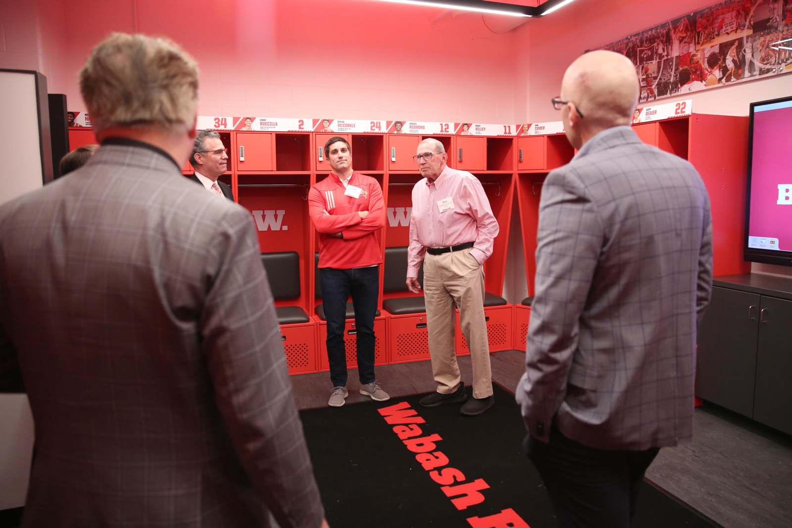 a group of men standing in a locker room