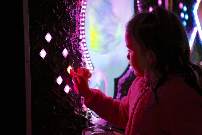 a girl touching a light up screen
