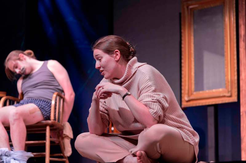 a woman sitting on a stage