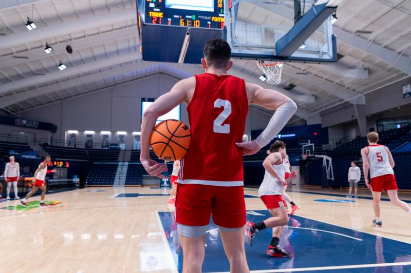 a man in a basketball uniform holding a basketball