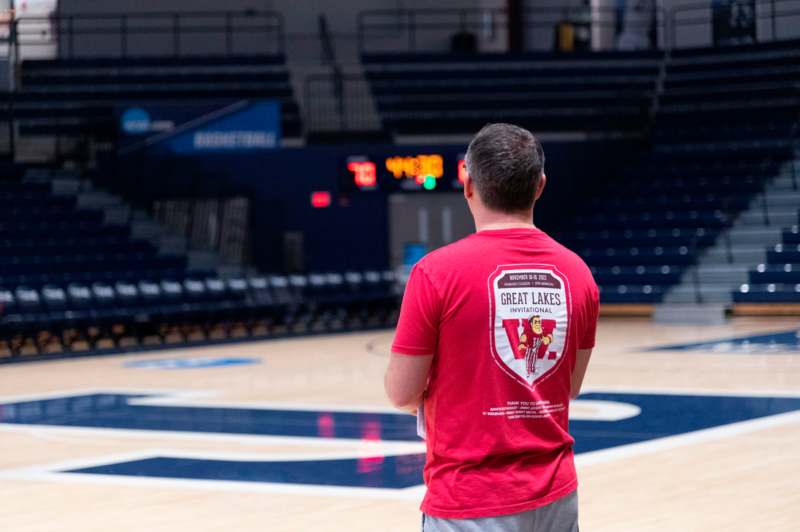 a man in a red shirt in a basketball court