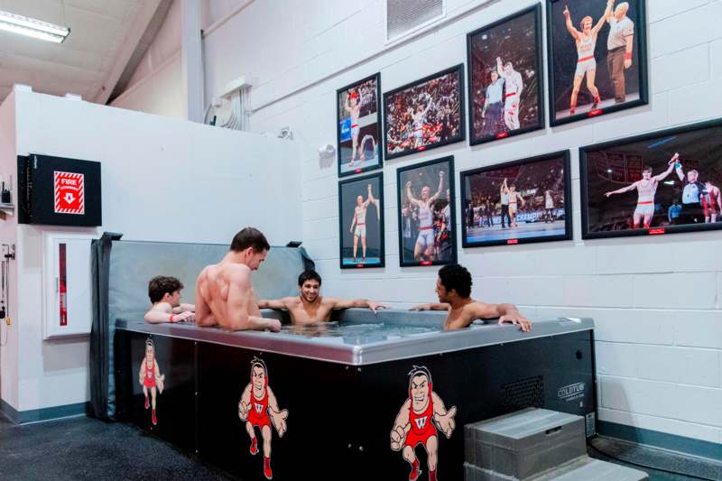 a group of men in a hot tub