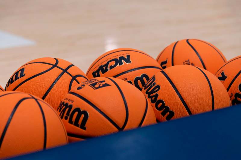 a group of basketballs on a blue surface