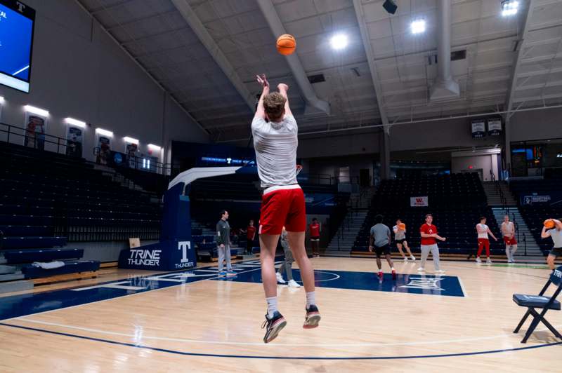 a man jumping to shoot a basketball