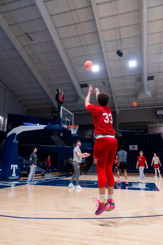a person in red uniform throwing a basketball