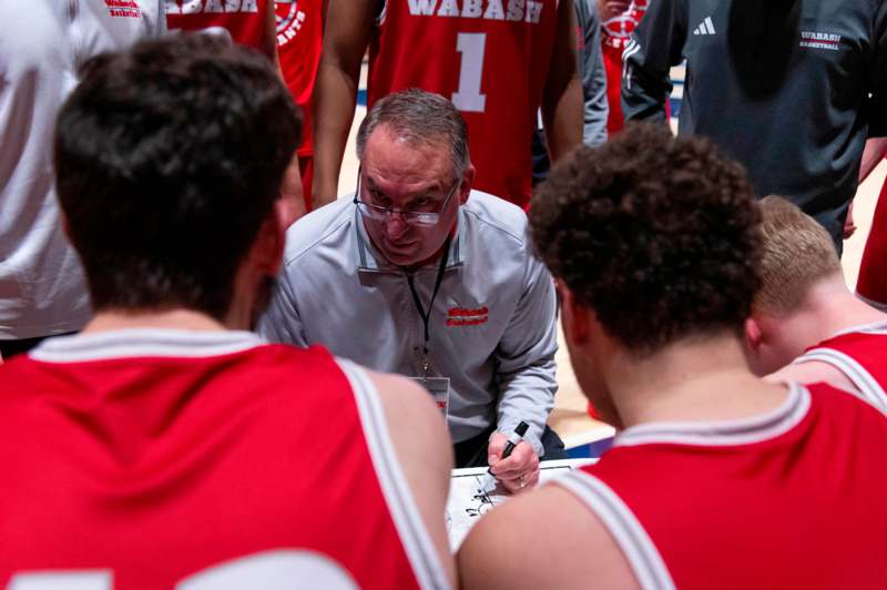 a basketball coach writing on a piece of paper