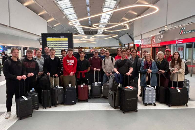 a group of people standing together with luggage