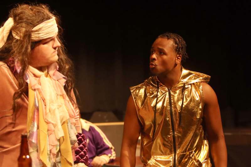 a man in a gold vest and a blindfold