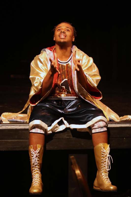 a man sitting on a stage