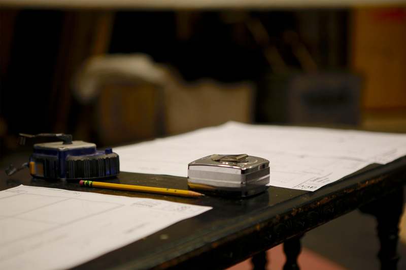a pencil and tape measure on a table