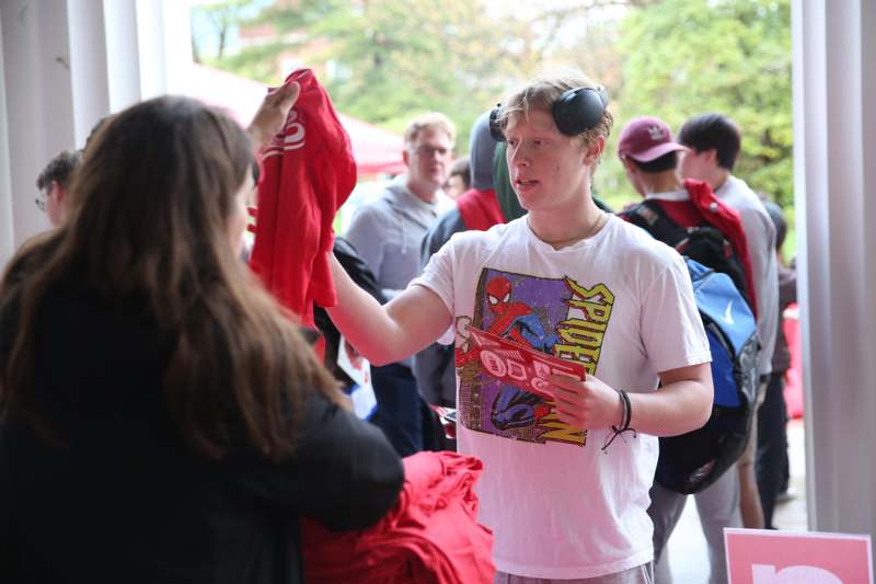 a man holding a red shirt