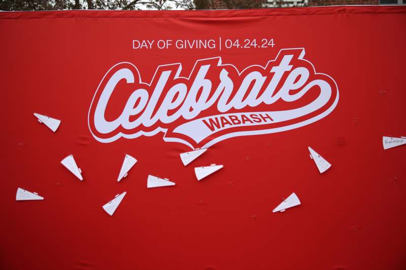 a red sign with white text and paper planes on it