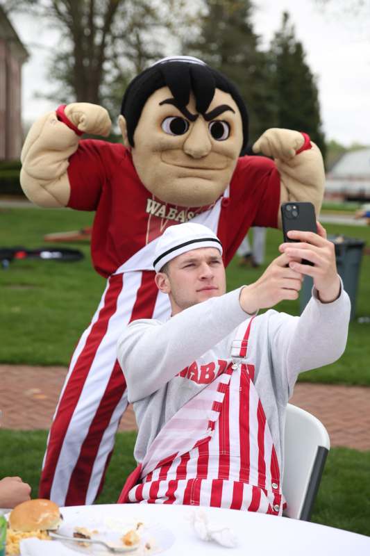 a man taking a selfie with a mascot