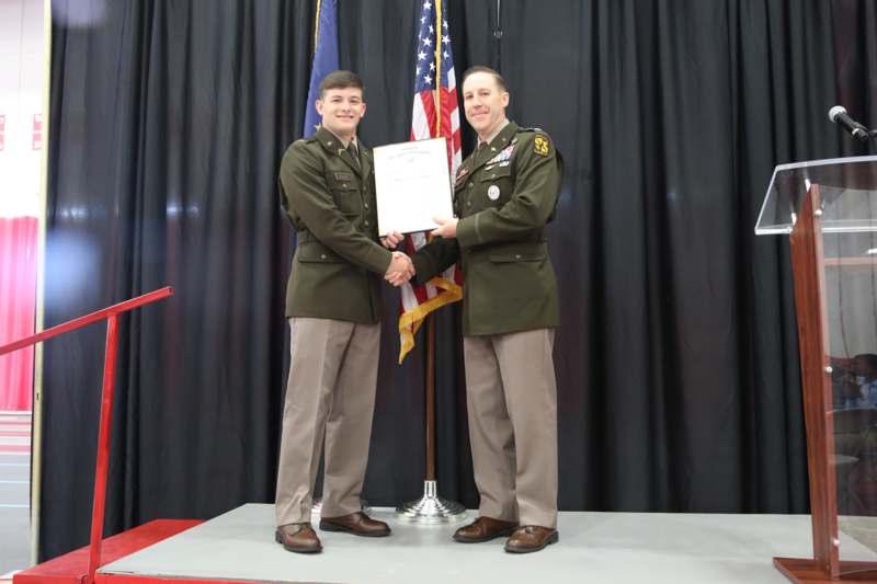 two men in military uniforms holding a piece of paper