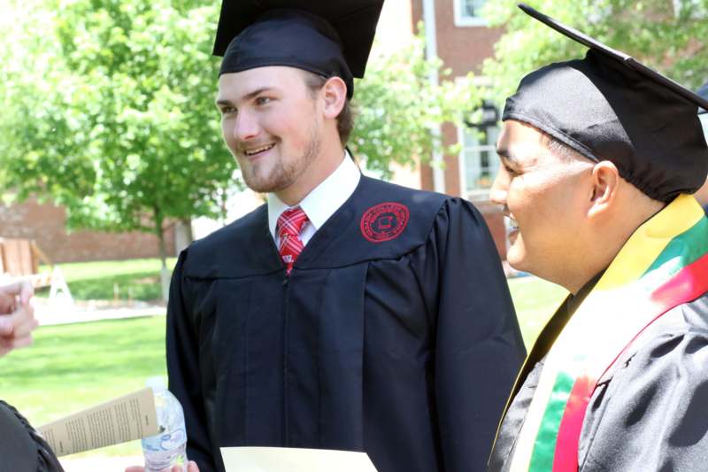 a man in a cap and gown smiling